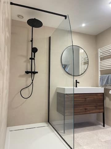 Douche avec colonne noire et paroi vitrée